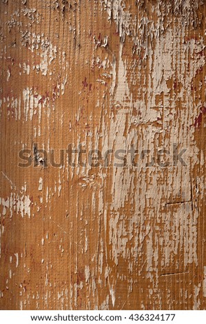 Wooden surface with an old paint peeling brown. Vertical image.