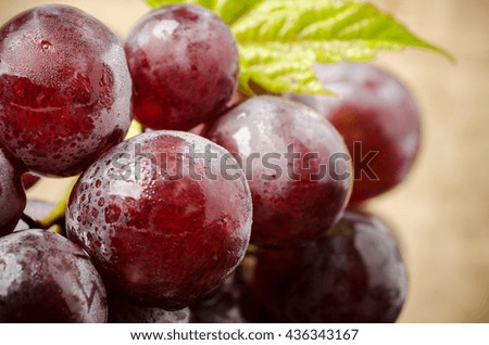 Red grapes on wooden background