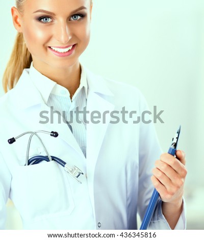 Smiling female doctor with a folder in uniform standing at hospital