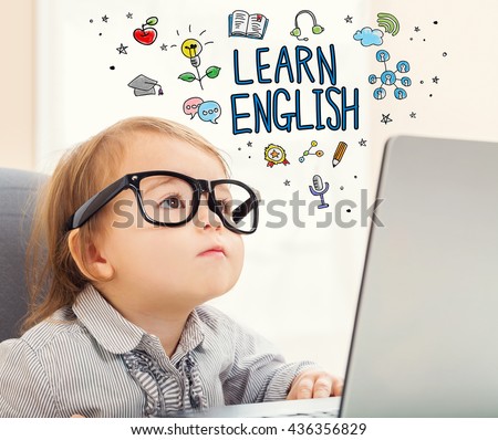 Learn English concept with toddler girl using her laptop