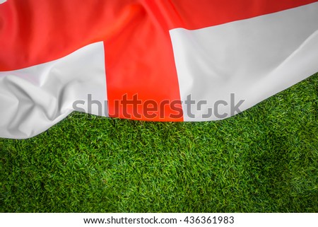 Flags of England on green grass