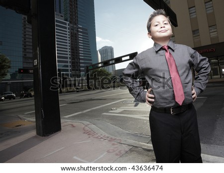 Young boy in business clothing posing on the street