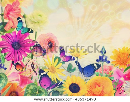 Colorful beautiful flowers and butterflies against magic sun light blurred background with sparkle spots. Summertime nature abstract. Toned colors image 
