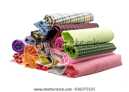 Pile of colorful checkered plaid fabric roll on a white background