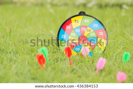 Dart arrows pin in the center of dart board (Business Concept),Dart arrow hitting in target bulls eye of dartboard, business solutions and success concept.