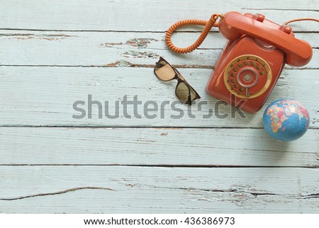 Camera, touristic maps, headphones, wallet with credit cards, phone, colorful pens, euro banknotes and coins on the white desk. Travel background. Journey planning. Tourist essentials. Space for text