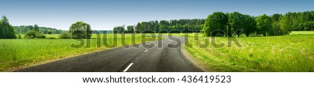 asphalt road panorama in countryside on sunny summer day Royalty-Free Stock Photo #436419523