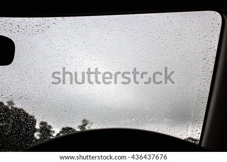 View from driver seat when raining and see rain drops on the window.
This picture is black and white tone to feel sad and waiting when raining. 