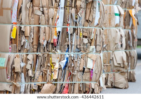 Bales of cardboard and box board with strapping wire ties Royalty-Free Stock Photo #436442611