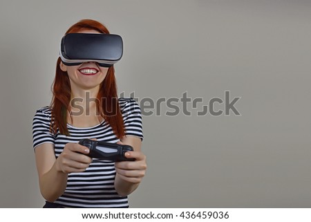 Young woman is having fun while playing video game in virtual reality