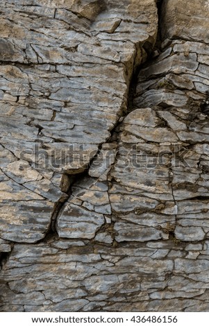 Stone wall of rock with cracks