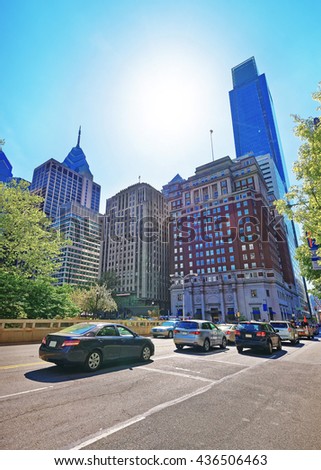 Road view on Penn Center with skyline of skyscrapers in Philadelphia, Pennsylvania, USA. It is a central business district in Philadelphia. Traffic on the road.