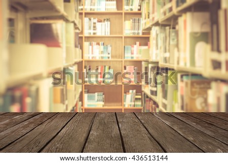 Blured books in public library with wood textured backgrounds