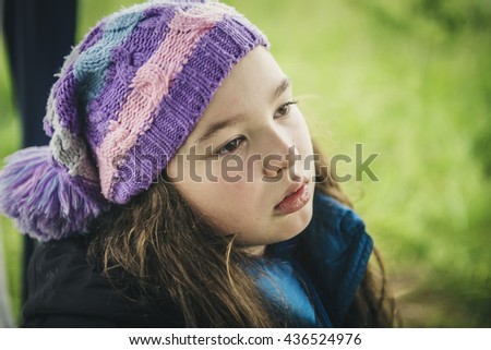 The sad girl in a knitted cap. 