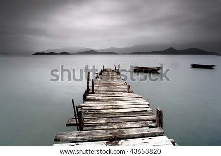 desolate pier and boat Royalty-Free Stock Photo #43653820