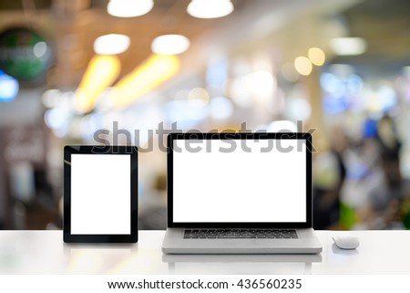 Conceptual workspace,Laptop and tablet with blank screen on table. interior background, blurred background