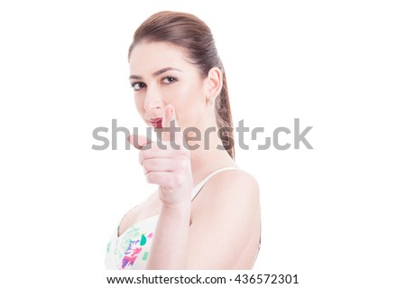 Attractive woman looking and pointing at camera with one hand isolated on white background with advertising area