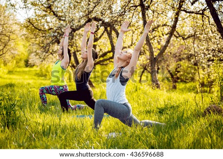 Young girls yoga in the park. Relax in nature