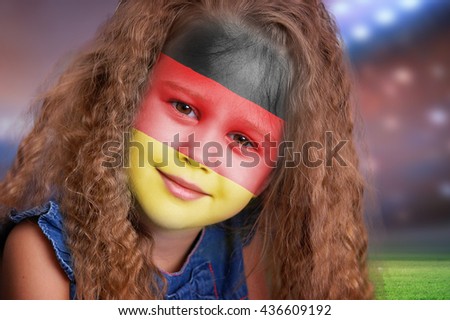 Soccer fan little girl portrait with flag of Germany on face