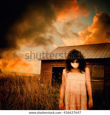 A scary ghost girl is wearing a white dress and an abandoned house shed is in the background with storm clouds for a fear or nightmare concept