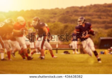 American football game - out of focus background of the field in the sunset