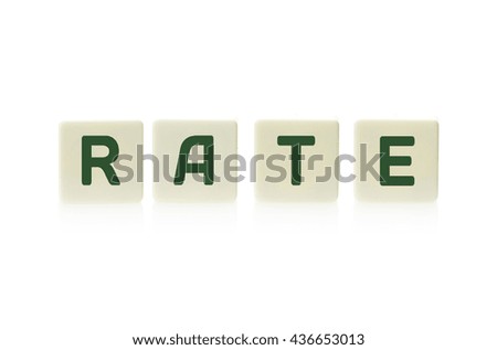 Word "Rate" on board game square plastic tile pieces, isolated on a white background.