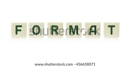 Word "Format" on board game square plastic tile pieces, isolated on a white background.
