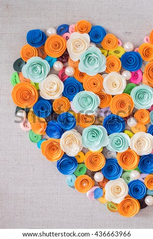 A heart made by colorful paper flowers.
