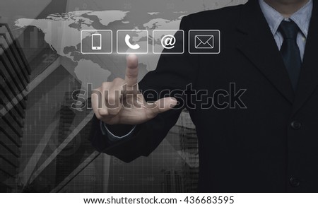 Businessman pressing telephone, mobile phone, at and email buttons over map and city tower, Customer support concept, Elements of this image furnished by NASA