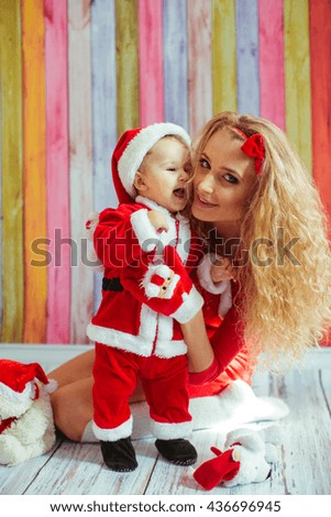 beautiful mom holding her  little Santa Claus