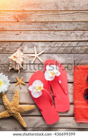 Beach accessories on wooden background, copyspace for text