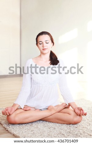 the girl sitting in the Lotus position