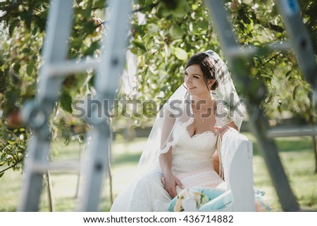 beautiful woman sitting on a bench in the garden