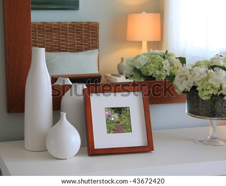 Picture frame and flowers on a dresser in a contemporary bedroom. (Picture in frame is mine.)