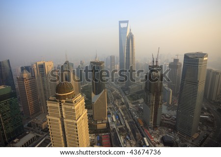  Bird view at Shanghai China. Skyscraper under construction in foreground. Fog, overcast sky and pollution. Bund (Pudong) area