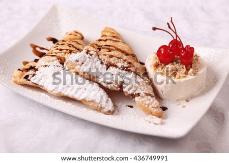 dessert with ice cream and a cherry on plate