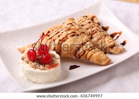 dessert with ice cream and a cherry on plate