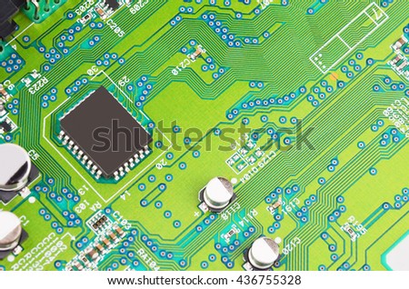 Green printed computer motherboard with microcircuit, close-up
