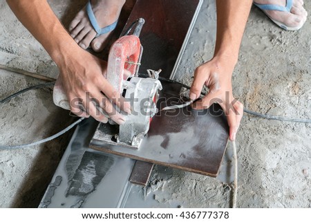 man carpenter builder working with electric jigsaw and wood
