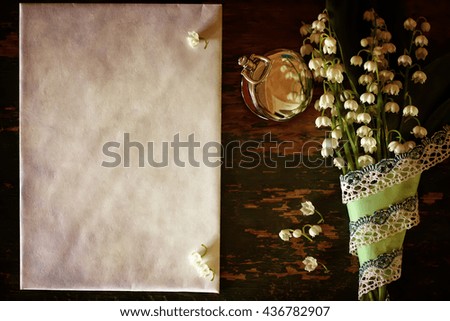 vintage effect on photo bouquet of lilies of the valley and space text