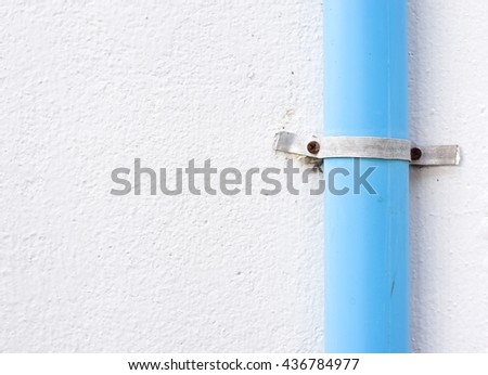PVC pipe for water piping system resident on wall.