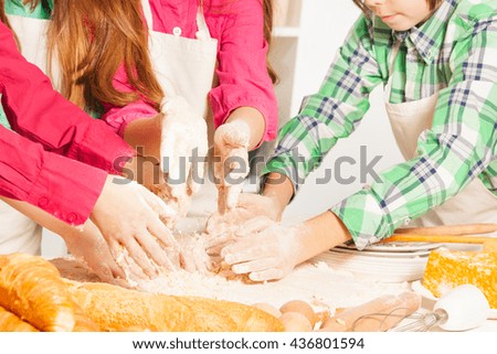 Close up picture of children's hands making dough