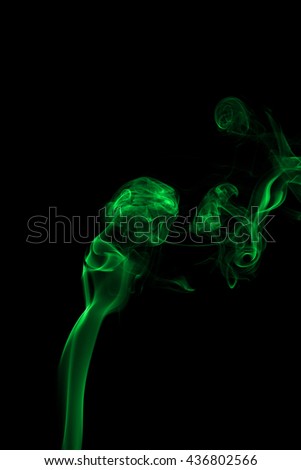 Abstract green smoke on black background from the incense sticks