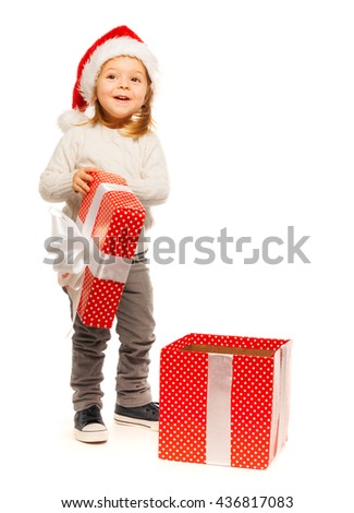 Surprised little girl opening her present