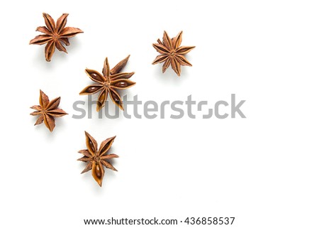 Star anise, scattered in a chaotic manner, isolated on white background Royalty-Free Stock Photo #436858537