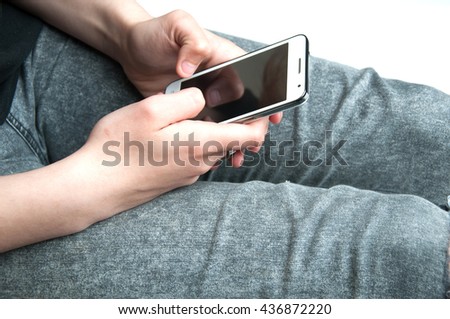 Girl holding a white smartphone. White background