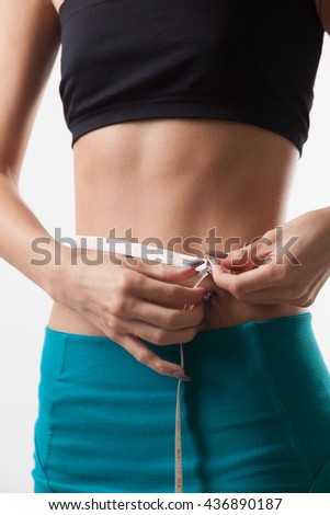 Slim tanned woman's body over white  background