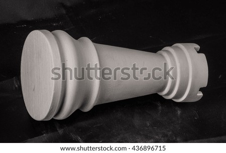 chess piece white plaster on a black background