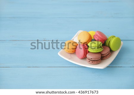 Sweet and colorful french macaroons on retro-vintage background