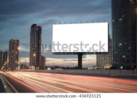Blank billboard on the highway during the twilight with city background with clipping path on screen.- can be used for display your products or promotional Royalty-Free Stock Photo #436925125